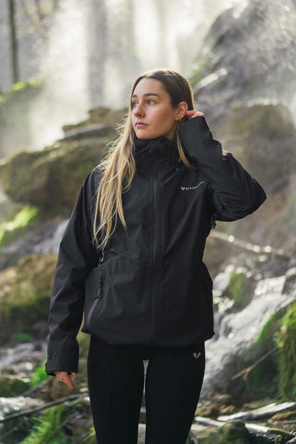 Model trägt BERGMENSCH Damen 3L Hardshell Regenjacke in der Farbe Black